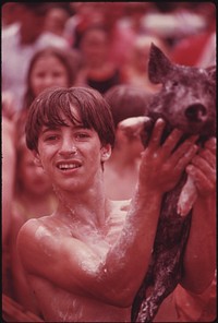 Rex Layne, 14, Triumphantly Holds Up One of the Greased Pigs He Caught at the Tennessee Consolidated Coal Company First Annual Picnic Held at a Tennessee Valley Authority Lake near Jasper and Chattanooga, Tennessee.