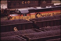 Closeup of a Railroad Engine and Coal Cars Loaded for Shipment to Customers at the Danville, West Virginia, near Charleston 04/1974. Photographer: Corn, Jack. Original public domain image from Flickr