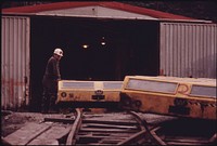 The General Mine Foreman at One of the Tennessee Consolidated Coal Company Mines near Jasper and Chattanooga Stands beside the Shuttle Cars Used to Transport the Miners to Work 08/1974. Photographer: Corn, Jack. Original public domain image from Flickr