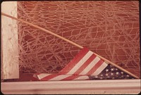 Old Flag and Frosted Window in Dock Square, the Center of Rockport. Photographer: Parks, Deborah. Original public domain image from Flickr