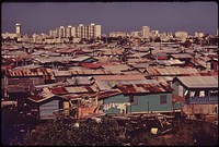 Modern Buildings Tower over the Shanties Crowded Along the Martin Pena Canal. Original public domain image from Flickr