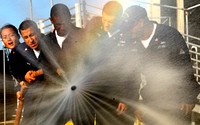 U.S. Sailors assigned to the Arleigh Burke-class destroyer USS Chung-Hoon (DDG 93) cycle through hose settings during the annual Surface Line Week?s damage control Olympics Nov. 30, 2009, in Pearl Harbor, Hawaii.