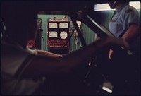 Woman Sits in Her Car Watching the Readings on the Exhaust Analyzer in an Auto Emission Inspection Station in Norwood, Ohio Her Auto Was Being Retested after Failing the First Time It Was Inspected. 08/1975. Photographer: Eiler, Lyntha Scott. Original public domain image from Flickr