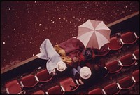 To Conserve Electricity All Portland High Schools Had Their Football Games Rescheduled for Daylight Hours at Multnomah Stadium. Normally They Were Played at Night. A Few Fans Are Shown Camped Under Rain Gear Watching a Game 10/1973. Photographer: Falconer, David. Original public domain image from Flickr