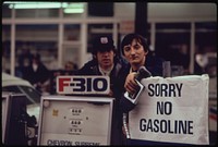 Gas Station Attendants Peer over Their "Out of Gas" Sign in Portland, on Day before the State's Requested Saturday Closure of Gasoline Stations 11/1973. Photographer: Falconer, David. Original public domain image from Flickr