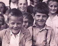 Lille, ME. Aug. 1942. Acadian children attending Catholic school. Group portrait, facing front, of children, with two boys in the foreground.  Original public domain image from Flickr