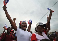 Earthquake survivors sing and dance on Toussant Boulevard to gospel music being played in Port-au-Prince, Haiti, Jan. 26, 2010.