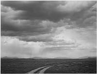 Roadway, low horizon, mountains, clouded sky, "Near (Grand) Teton National Park." Photographer: Adams, Ansel, 1902-1984. Original public domain image from Flickr