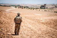 A U.S. Soldier provides security during a coordinated, independent patrol along the demarcation line near a village outside Manbij, Syria, June 26, 2018.