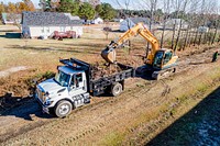 Stormwater ImprovementsGreenville Public Works clearing an overgrown stormwater ditch to reduce flooding.