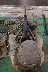 U.S. Marine Corps Cpl. Robert Dyke fires an M2 .50-caliber machine gun during the crew served weapons firing exercise on a range at the Pohakuloa Training Area in Hawaii April 10, 2010.