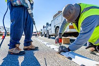 Traffic delineator installation at Charles Blvd and Smythewick Dr, part of the City's effort to improve traffic safety. November 21, 2018. Original public domain image from Flickr