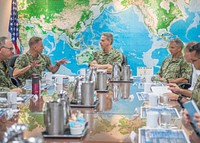 U.S. Navy Rear Adm. Murray Joe Tynch III, the commander of Logistics Group Western Pacific/Task Force 73 (COMLOG WESTPAC/CTF73), left, briefs U.S. Indo-Pacific commander Adm. Phil Davidson, center, at COMLOG WESTPAC/CTF73 headquarters in Singapore, March 6, 2019.