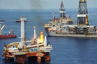 The drillship Discoverer Enterprise, right, and other vessels conduct flaring operations to mitigate the effects of the Deepwater Horizon oil spill June 25, 2010, in the Gulf of Mexico.