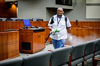 City staff spray disinfectant in the City Hall Council Chambers on Friday, March 20, 2020. Original public domain image from Flickr