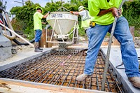 Engineers inspect a portion of the new culvert as the last two sections of the culvert between Reade Circle and 8th Street are joined together with poured concrete, May 13, 2020. Original public domain image from Flickr