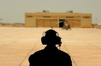 U.S. Air Force Tech. Sgt. Adam Nixon, a C-130H Hercules aircraft loadmaster assigned to the 746th Expeditionary Airlift Squadron, sits at the end of the ramp waiting for ground crew to unload cargo in support of humanitarian relief efforts in Pakistan Aug. 22, 2010.