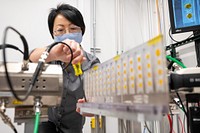 APS Beamline scientist fixing equipment. Argonne National Laboratory, December 3, 2020. Original public domain image from Flickr