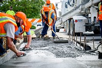 Public Works Streets Division constructs an ADA-compliant crosswalk ramp on E 10th Street, August 28. Original public domain image from Flickr