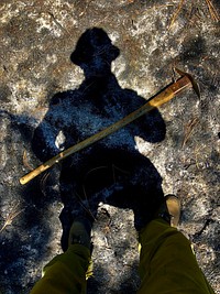 Firefighter silhouette with tool. Original public domain image from Flickr