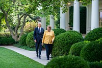 President Joe Biden and German Chancellor Angela Merkel walk through the Rose Garden of the White House on Thursday, July 15, 2021, en route to the East Room to participate in a press conference. (Official White House Photo by Adam Schultz). Original public domain image from Flickr