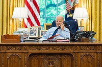 President Joe Biden talks on the phone with U.S. Sen. Angus King, I-Maine, during congressional call time on Friday, July 16, 2021, in the Oval Office of the White House. (Official White House Photo by Adam Schultz). Original public domain image from Flickr