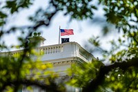 The American flag and the POW/MIA flag fly above the White House. Original public domain image from Flickr