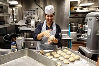 Hull Technician 3rd Class Tiffany Mendoza, assigned to the Arleigh Burke-class guided-missile destroyer USS Porter (DDG 78), prepares bread, Sept. 14, 2021. (U.S. Navy photo by Mass Communication Specialist 2nd Class Katie Cox) Original public domain image from Flickr