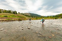 Backpackers crossing lake. Original public domain image from Flickr