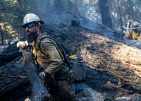 Cade Grismer, El Dorado Hot Shot, conducts wet mop duties during the Caldor Fire on the El Dorado National Forest, California. USDA Forest Service photo by Cecilio Ricardo. Original public domain image from Flickr