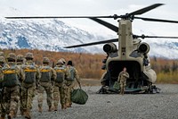 U.S. Army paratroopers assigned to the 4th Infantry Brigade Combat Team (Airborne), 25th Infantry Division, U.S. Army Alaska, prepare to board a CH-47 Chinook operated by the 1-52nd General Service Aviation Battalion at Malemute Drop Zone on Joint Base Elmendorf-Richardson, Alaska, October 5, 2021. (U.S. Air Force photo by Airman 1st Class Patrick Sullivan). Original public domain image from Flickr
