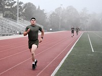 A soldier running on running track. Original public domain image from Flickr