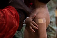 Children vaccination, bandaged arm. Original public domain image from Flickr