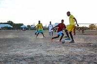 Boys playing football. Original public domain image from Flickr