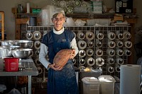 A member of the Sang Lee Farms kitchen staff holds a sweat potato weighing more than eight pounds, in Peconic, New York, November 5, 2021. (FPAC photo by Preston Keres). Original public domain image from Flickr