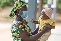 Mother and child outside at Balaza Alcali Health Centre, Far North Region, Cameroon, September 22 2021. Original public domain image from Flickr