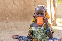 Child taking malaria medication at her family's home in Balaza, September 23, 2021. Original public domain image from Flickr