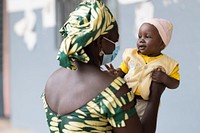 Boussoura Marie and her 8-month-old son wait to be served at Balaza Alcali Health Centre, Far North Region, Cameroon, on 22nd September 2021. Original public domain image from Flickr