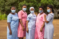 Nurses pose outside health center. Original public domain image from Flickr