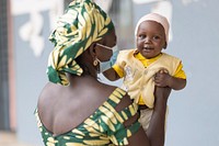 Boussoura Marie and her 8-month-old son wait to be served at Balaza Alcali Health Centre, Far North Region, Cameroon, on 22nd September 2021. Original public domain image from Flickr