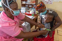 Child receiving malaria testing and treatment in Sierra Leone, August 10. 2021.  Original public domain image from Flickr