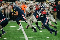 The U.S. Naval Academy Midshipmen face off against the U.S. Army Black Knights during the annual Army-Navy football game at Metlife Stadium. East Rutherford, N.J., December 11, 2021. Original public domain image from Flickr