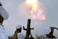 Soldiers shooting a mortar. Original public domain image from Flickr