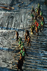 U.S. Sailors aboard the aircraft carrier USS Ronald Reagan (CVN 76) scrub the flight deck Nov. 14, 2010, while under way in the Pacific Ocean preparing for a deployment.