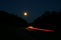 Car Tail Lights on a Nighttime Road.