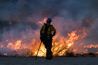 A USFWS firefighter monitors a prescribed fire in Browns Park National Wildlife Refuge in 2021. Original public domain image from Flickr