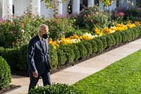 President Joe Biden walks through the White House Rose Garden, Thursday, November 4, 2021, to the Oval Office. (Official White House Photo by Adam Schultz) This official White House photograph is being made available only for publication by news organizations and/or for personal use printing by the subject(s) of the photograph. The photograph may not be manipulated in any way and may not be used in commercial or political materials, advertisements, emails, products, promotions that in any way suggests approval or endorsement of the President, the First Family, or the White House.