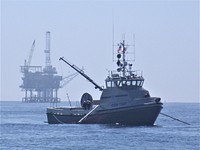 Oil Spill Response VesselMay 9, 2012 Santa Barbara Channel, California An oil spill removal organization (OSRO), deploys one of its response vessels during a training session with its spill response operating team (SROT). In this photo the response vessel has deployed side arm collection systems on both sides of the vessel. As the response vessel moves forward, oil on the surface of the water is herded into the collection pocket formed by the booms stretched on the outriggers. The trapped oil is then removed from the pocket by skimmers located inside the vessel or lowered over the side. BSEE Preparedness Analysts from the Oil Spill Preparedness Division (OSPD) regularly inspect these types of equipment and observe industry training and exercise activities to ensure compliance with regulations and to monitor the overall vigor of the oil spill preparedness and response community. Photo by: Craig Ogawa, BSEE