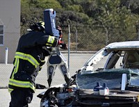 Firefighter using Jaws of Life. Original public domain image from Flickr