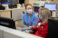 U.S. Navy medical response team learns the ropes at Indiana hospital 211223-A-HH158-1021INDIANAPOLIS -- U.S. Navy Lt. Jesse Althaus, an emergency room registered nurse assigned to medical response team-Indianapolis, and Erika Hill, a registered nurse at Indiana University Health Methodist Hospital, discuss medical protocols at the hospital in Indianapolis, Indiana, Dec. 22, 2021. U.S. Northern Command, through U.S. Army North, remains committed to providing flexible Department of Defense support to the whole-of-government COVID response. (U.S. Army photo by Spc. Raekwon Jenkins)